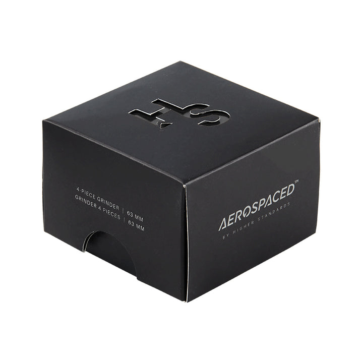 Large black 4 piece Aeropspaced grinder inside it's packaging.